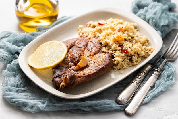 Fried mear with fresh tabbouleh on small plate on ceramic