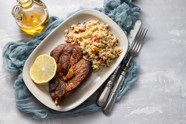 Fried mear with fresh tabbouleh on small plate on ceramic