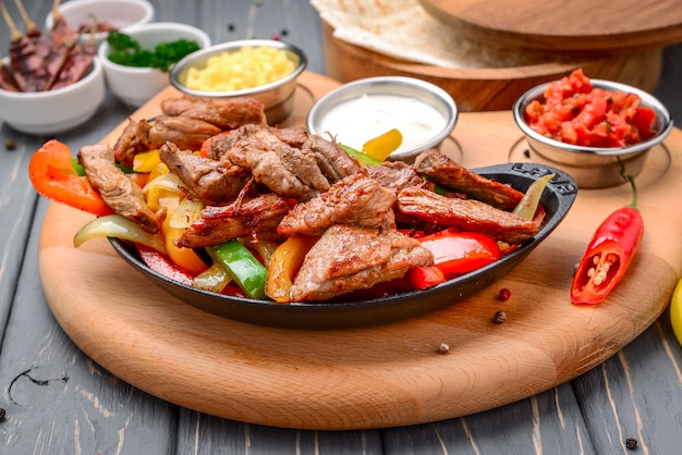 Fried meat with different vegetables with sauce