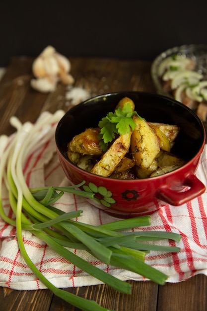 fried new potatoes with sauce and greens with herring tomato and green onion