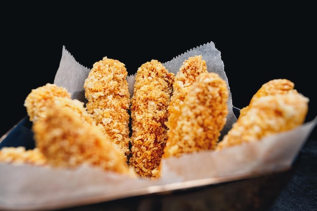 Fried nuggets with chicken on a dark background