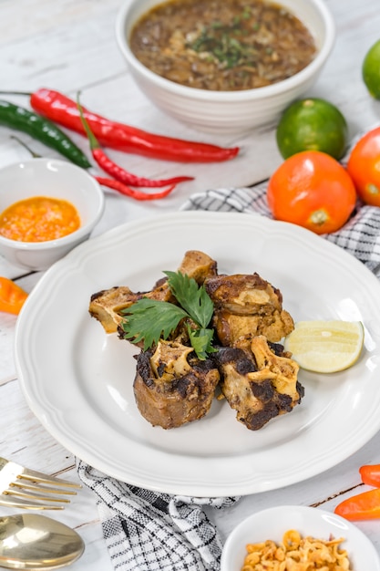 Fried oxtail served on a table with lemon slices