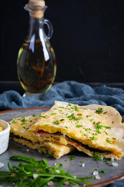 Fried pita bread with scrambled eggs tomatoes meat and cheese Stuffed lavash