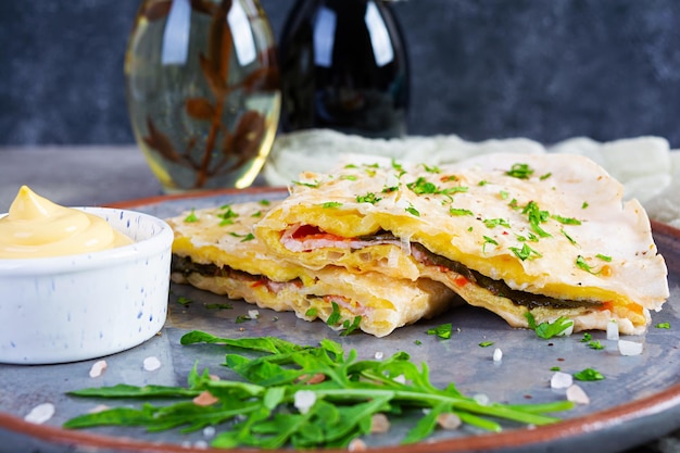 Fried pita bread with scrambled eggs tomatoes meat and cheese Stuffed lavash