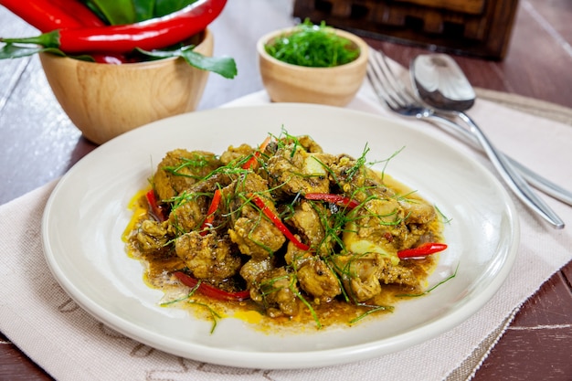 Fried pork bones spicy with yellow curry paste on dish thai style food 