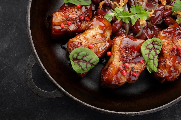 Fried pork ribs with ketchup and herbs