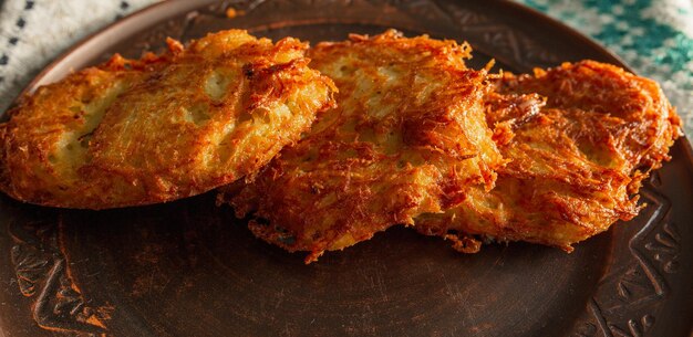 Fried potato pancakes on a clay brown plate food potato pancakes dish