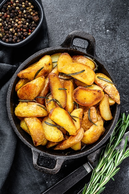 Fried potato wedges, French fries in a pan 