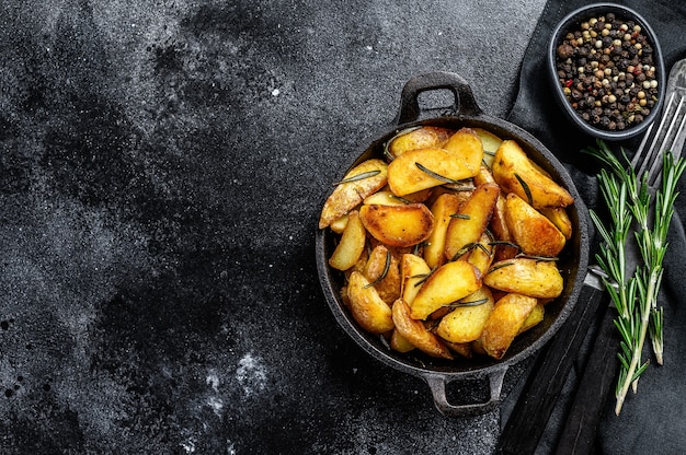 Fried potato wedges, French fries in a pan.