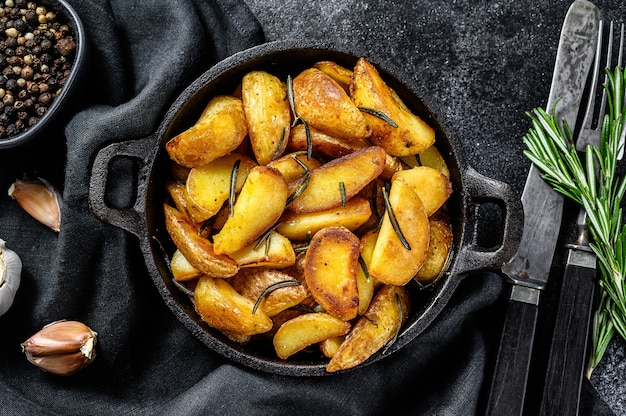 Fried potato wedges in pan