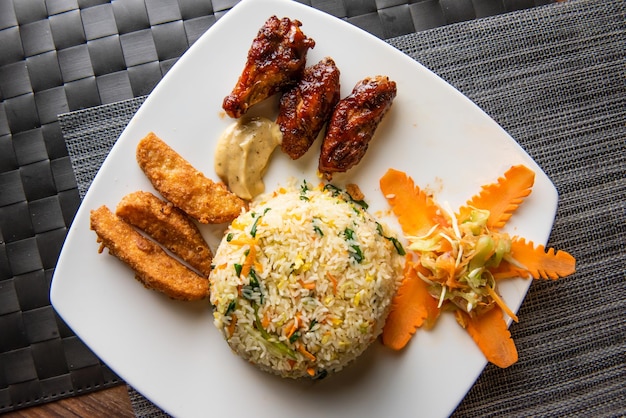 Fried rice chicken wings Potato wedges and salad served in dish top view of fastfood