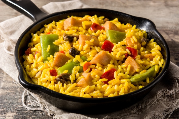 Fried rice with chicken and vegetables on frying iron pan