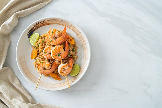 Fried rice with shrimps skewers