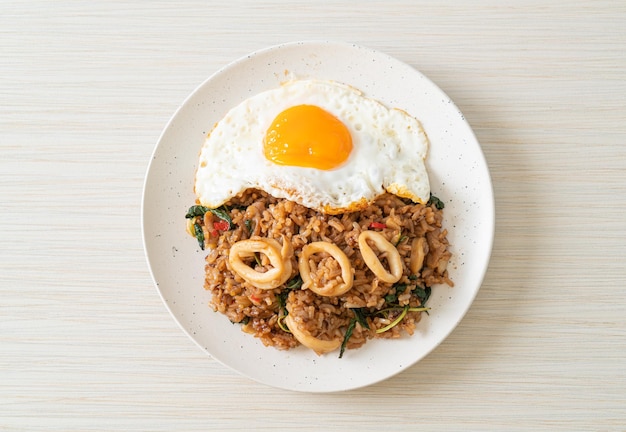 Fried rice with squid and basil topped fried egg in Thai style