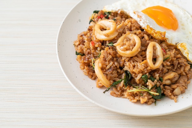 fried rice with squid and basil topped fried egg in Thai style