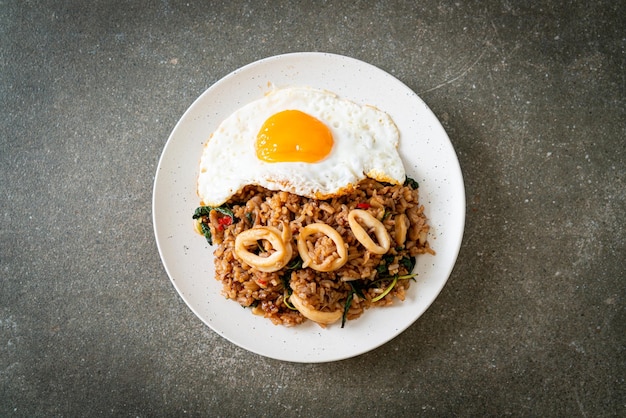 fried rice with squid and basil topped fried egg in Thai style