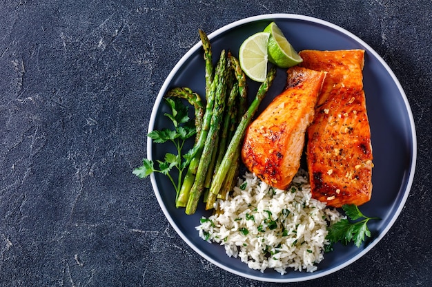 Fried salmon fish fillet with rice and asparagus