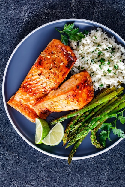 Fried salmon fish fillet with rice and asparagus