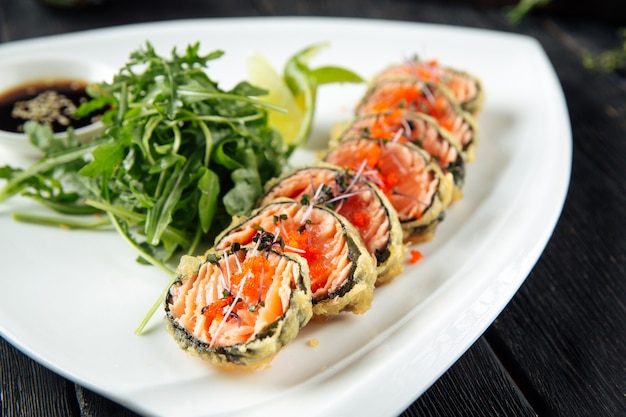 Fried salmon rolls with arugula and soy sauce