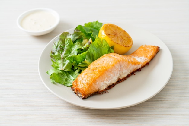 Fried salmon steak with lemon and vegetable