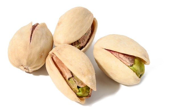 Fried salted pistachios in shell on white isolated background delicious snack