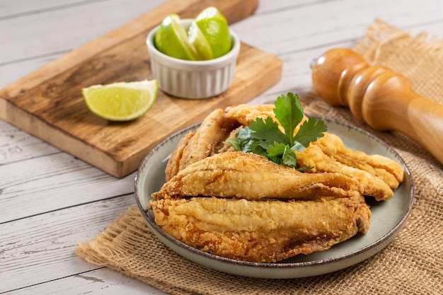 Fried sardines in the plate on the table.