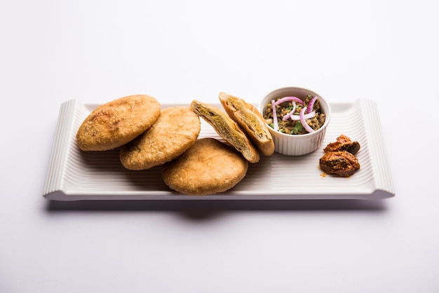 Fried Sattu Litti chokha served with Baingan Bharta, onion and pickle, popular recipe from Bihar, India