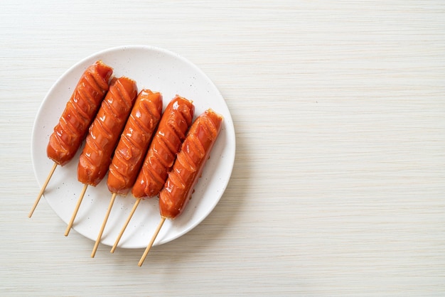 Fried sausage skewer on plate