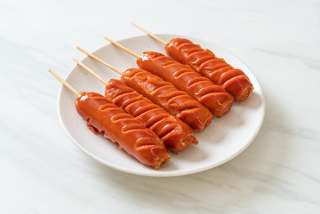 fried sausage skewer on white plate