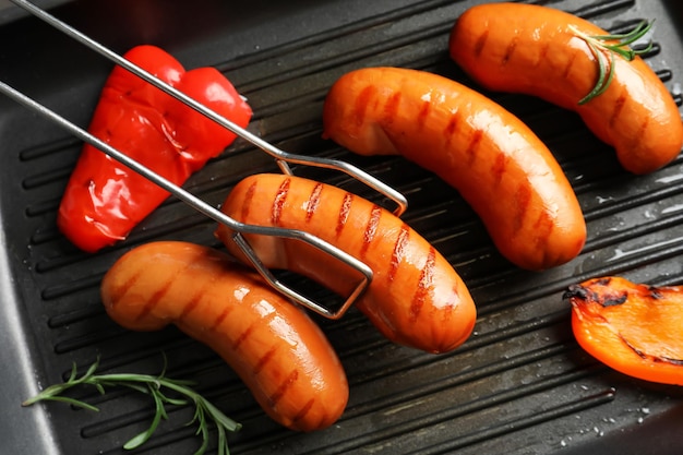 Fried sausages on grill pan