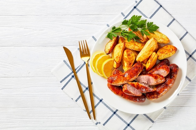 Fried sausages on a plate with potatoes