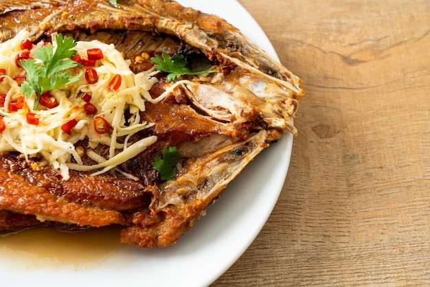 Fried Sea Bass Fish with Fish Sauce and Spicy Salad