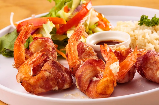 Fried shrimp with bacon, sweet sauce, salad and rice, food, gastronomy