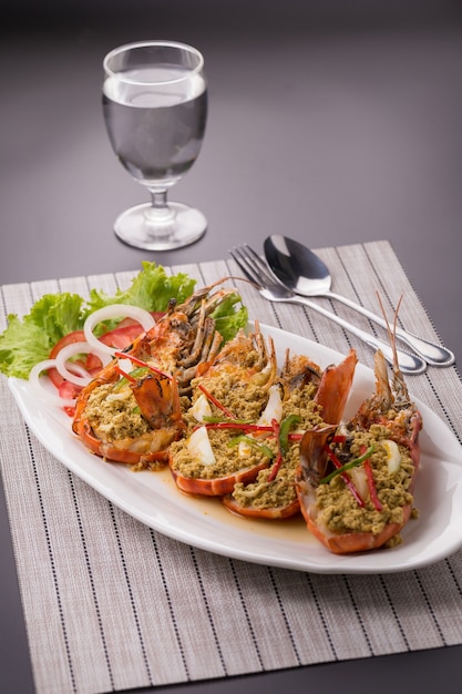 fried shrimp with curry in a white plate.