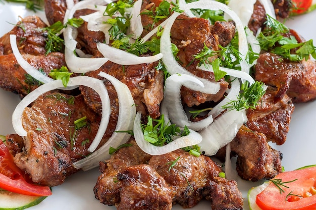 Fried skewers on the grill in a white dish