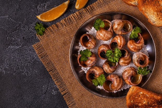 Fried snails with lemon baguette and parsley