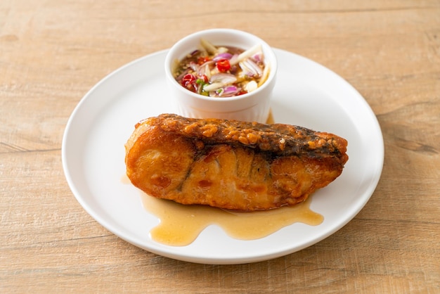 Fried snapper fish with fish sauce and spicy salad