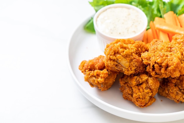 fried spicy chicken wings with vegetable