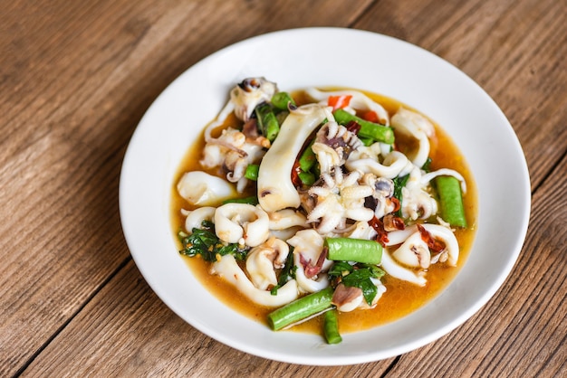 Fried squid with holy basil on white plate