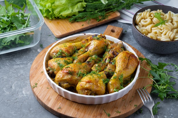 Fried tasty chicken drumstick served in white bawl with spices