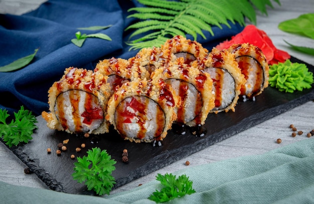 Fried tempura sushi rolls with chicken cream cheese smoked chicken tomato and bell peppers Traditional Japanese Cuisine