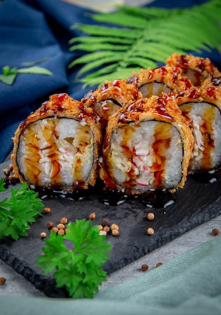 Fried tempura sushi rolls with crab cream cheese and gherkin in batter Traditional Japanese Cuisine