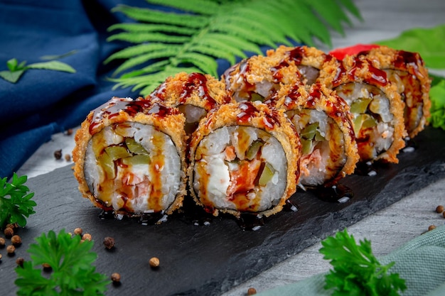 Fried tempura sushi rolls with shrimp cream cheese gherkin in batter Traditional Japanese Cuisine