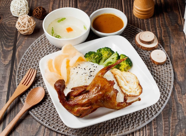 Fried Turtledove Rice with sauce and soup served in dish isolated on table side view of taiwan food