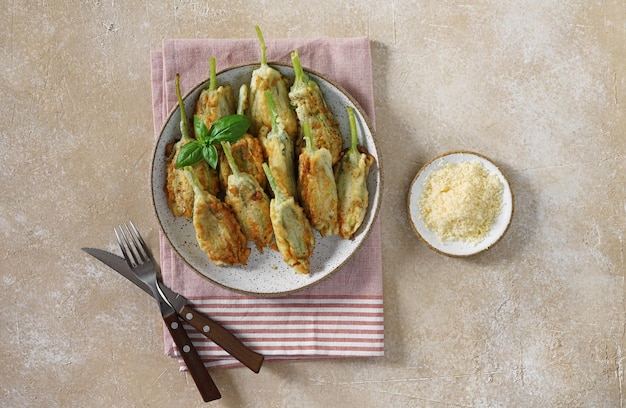 Fried zucchini flowers stuffed with cream cheese served on the plate tasty Italian dish summer top view