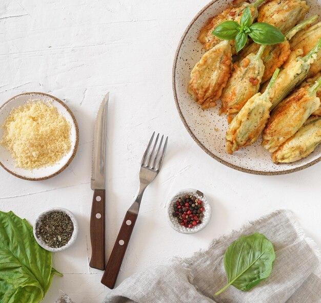 Fried zucchini flowers stuffed with cream cheese served on the plate tasty Italian dish summer top view