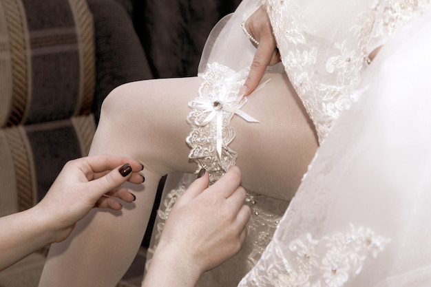 Friend of the bride wears her wedding garter. beauty and fashion in women's clothing