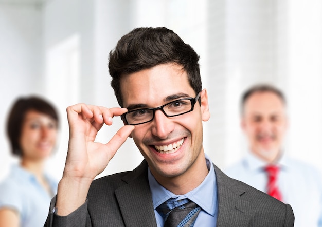 Friendly businessman portrait in front of his team