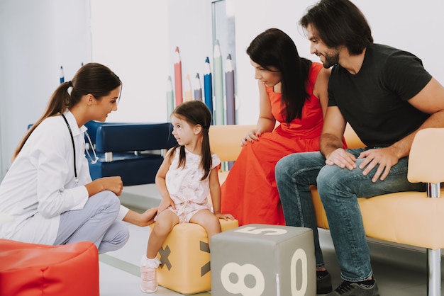 Friendly Doctor and Family at Pediatrician Office