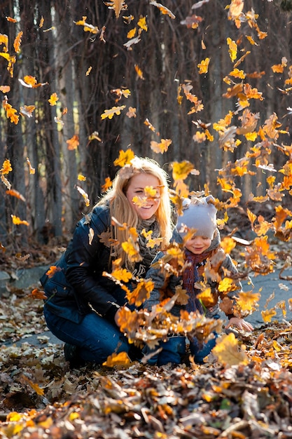 Friendly family on a walk during the fall of the leaves in the park